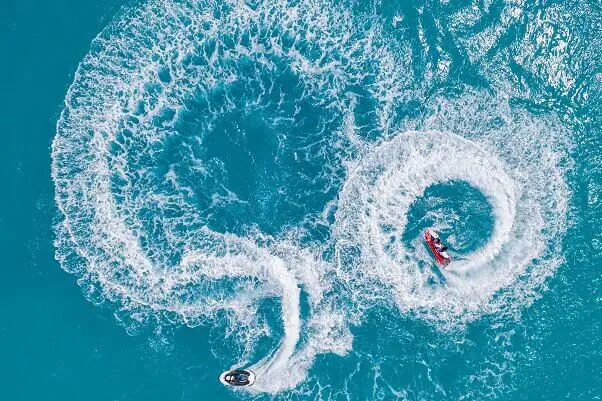 Aerial view jet skis playing tropical ocean