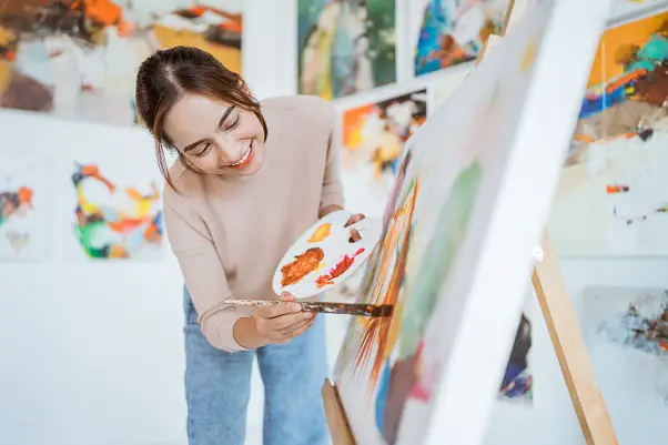Female artist painting canvas