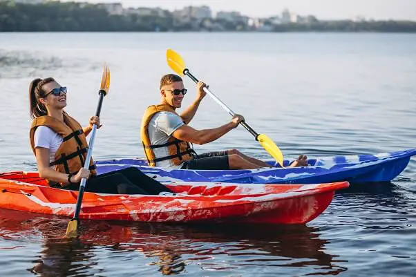 Couple together kayaking river
