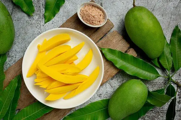 Pickled mango dark wooden surface